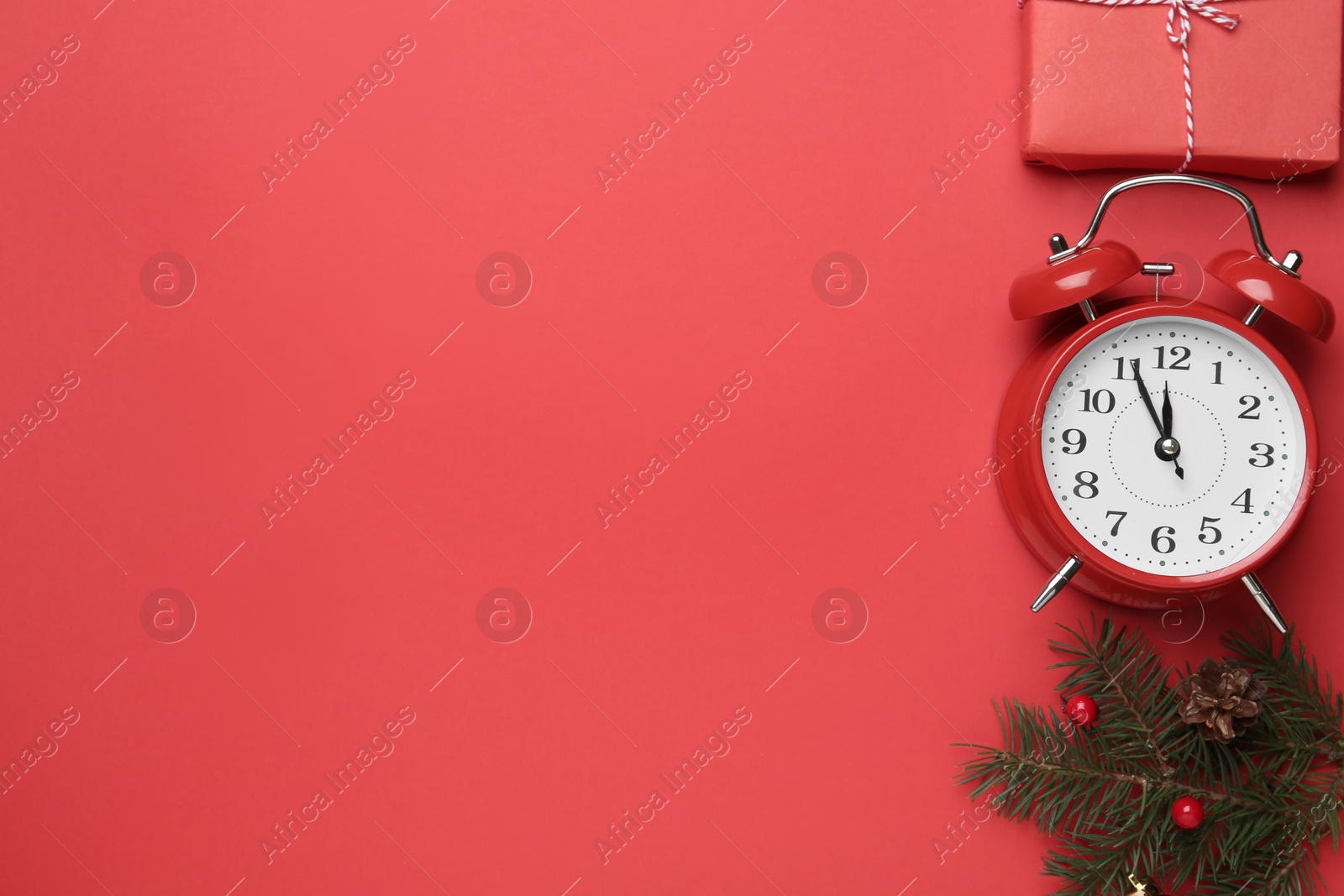 Photo of Flat lay composition with alarm clock and Christmas gift on red background, space for text. Boxing day