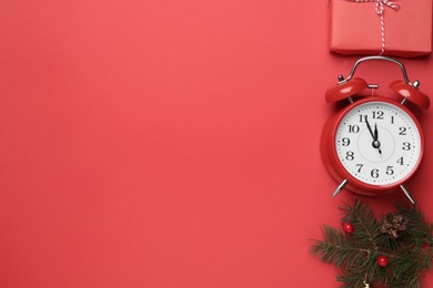 Flat lay composition with alarm clock and Christmas gift on red background, space for text. Boxing day