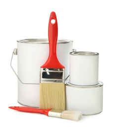 Photo of Paint cans and brushes on white background