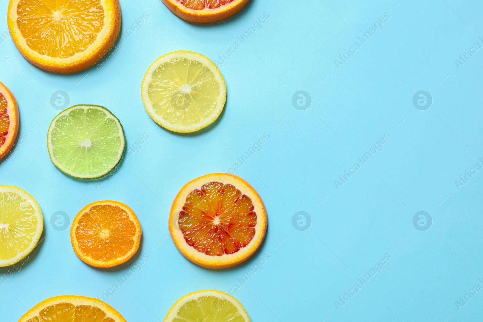 Photo of Different citrus fruits on color background, flat lay. Space for text