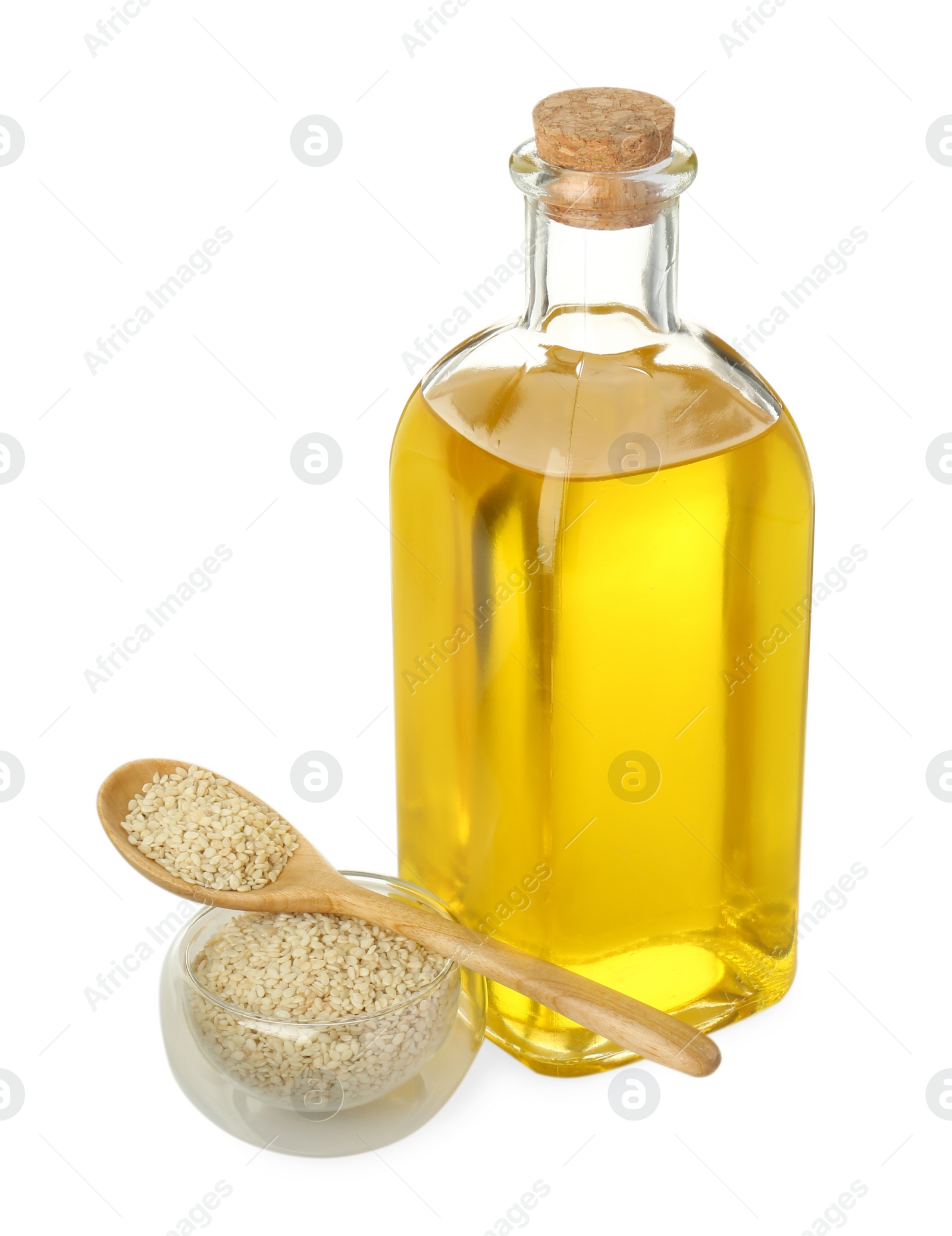 Photo of Vegetable fats. Sesame oil in glass bottle and seeds isolated on white