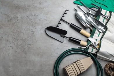 Photo of Flat lay composition with gardening tools on grey background, space for text