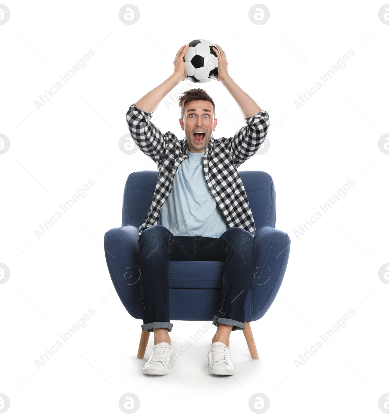 Photo of Handsome young man sitting in armchair and watching soccer match on white background