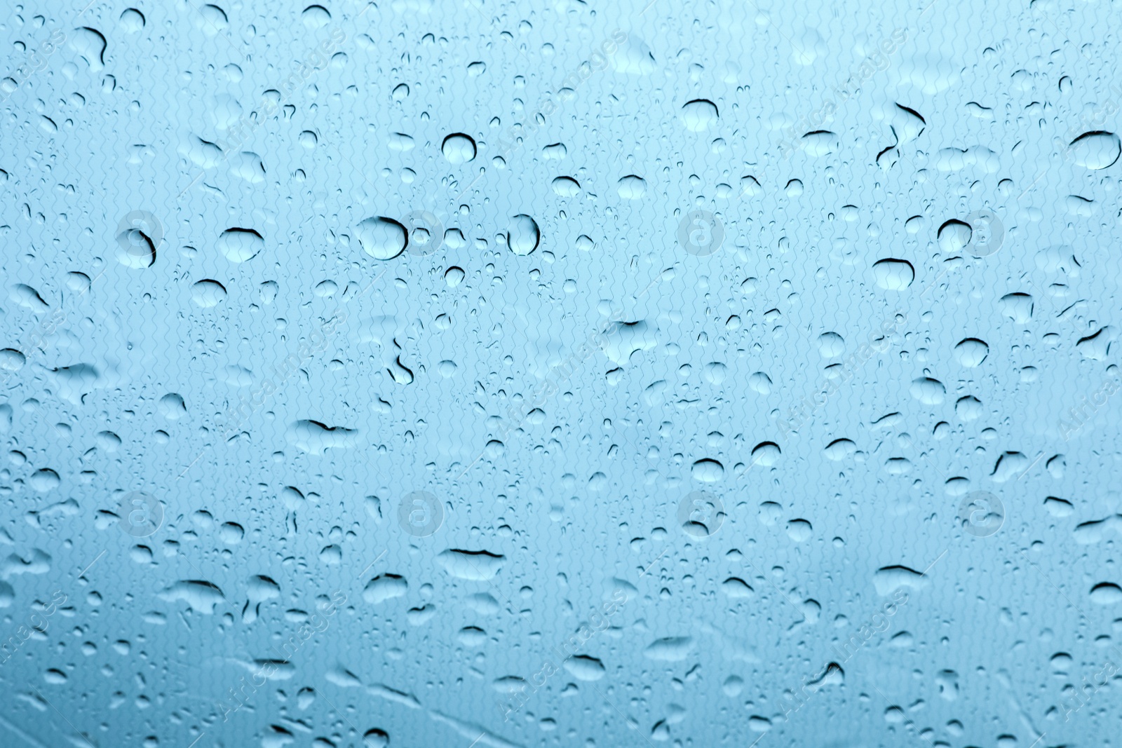 Photo of Window glass with water drops, closeup view