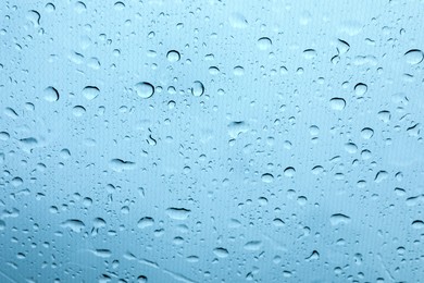 Photo of Window glass with water drops, closeup view