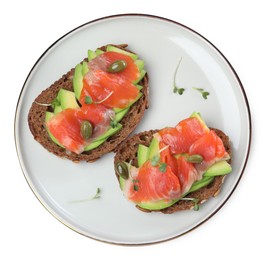 Photo of Delicious sandwiches with salmon, avocado and capers on white background, top view