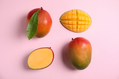 Photo of Flat lay composition with ripe mangoes on color background
