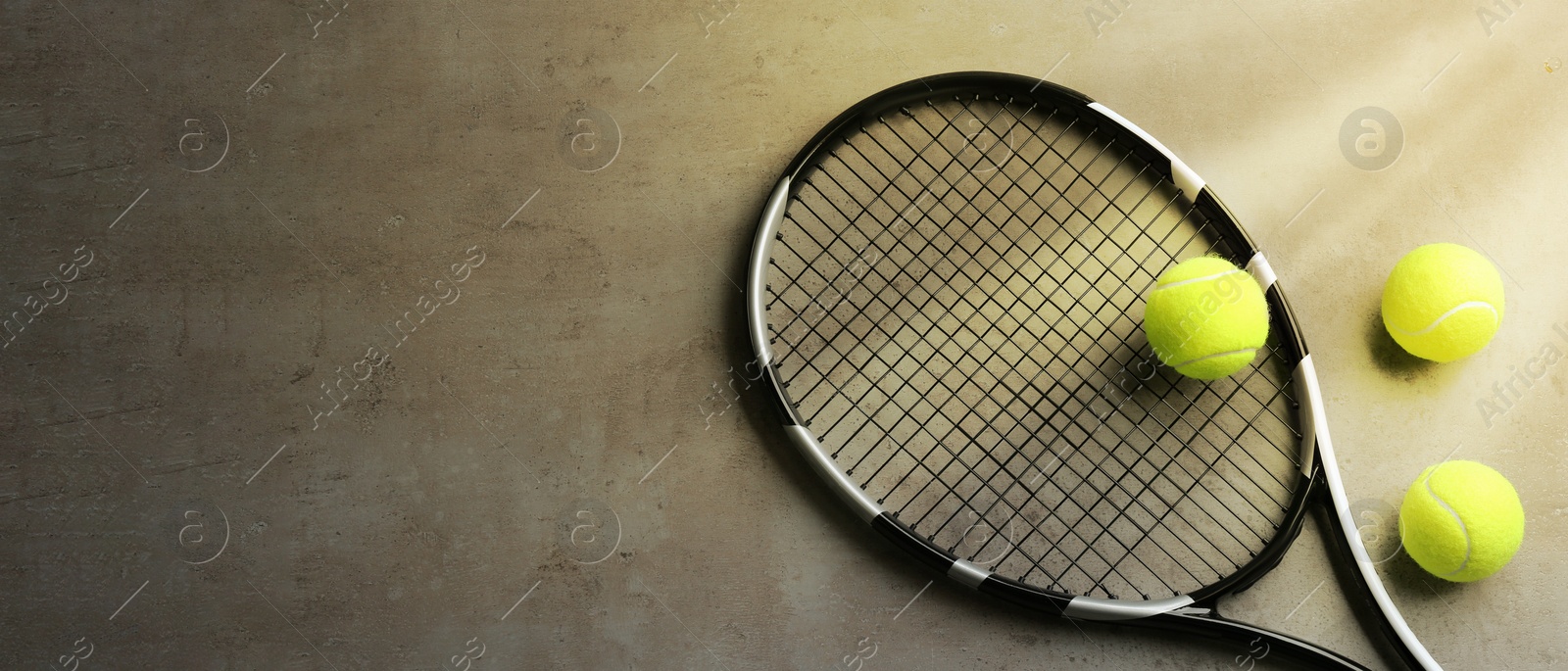 Image of Tennis racket and balls on grey table, flat lay. Banner design with space for text