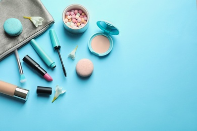 Photo of Makeup products with cosmetic bag on color background