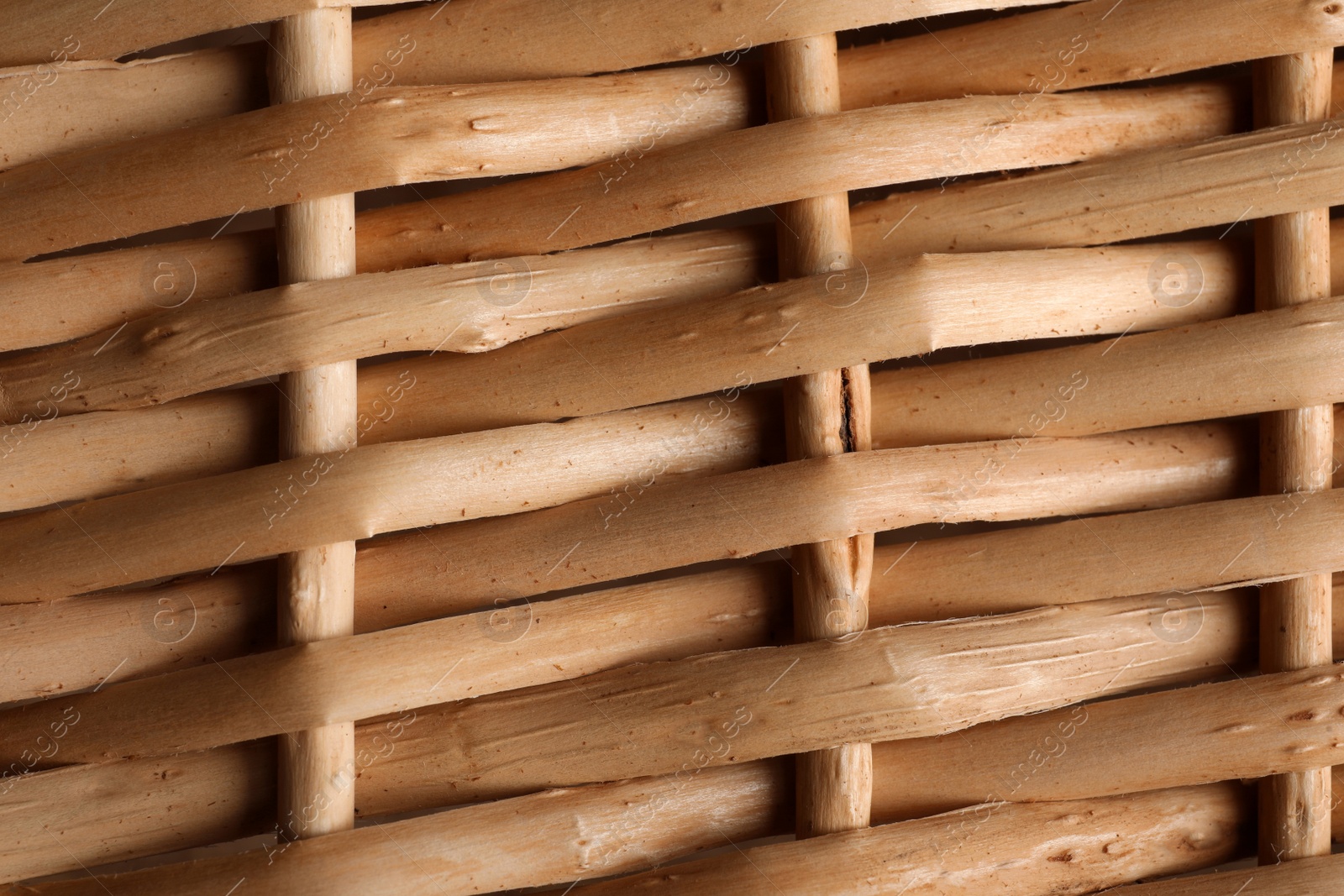 Photo of Handmade wicker basket made of natural material as background, closeup view