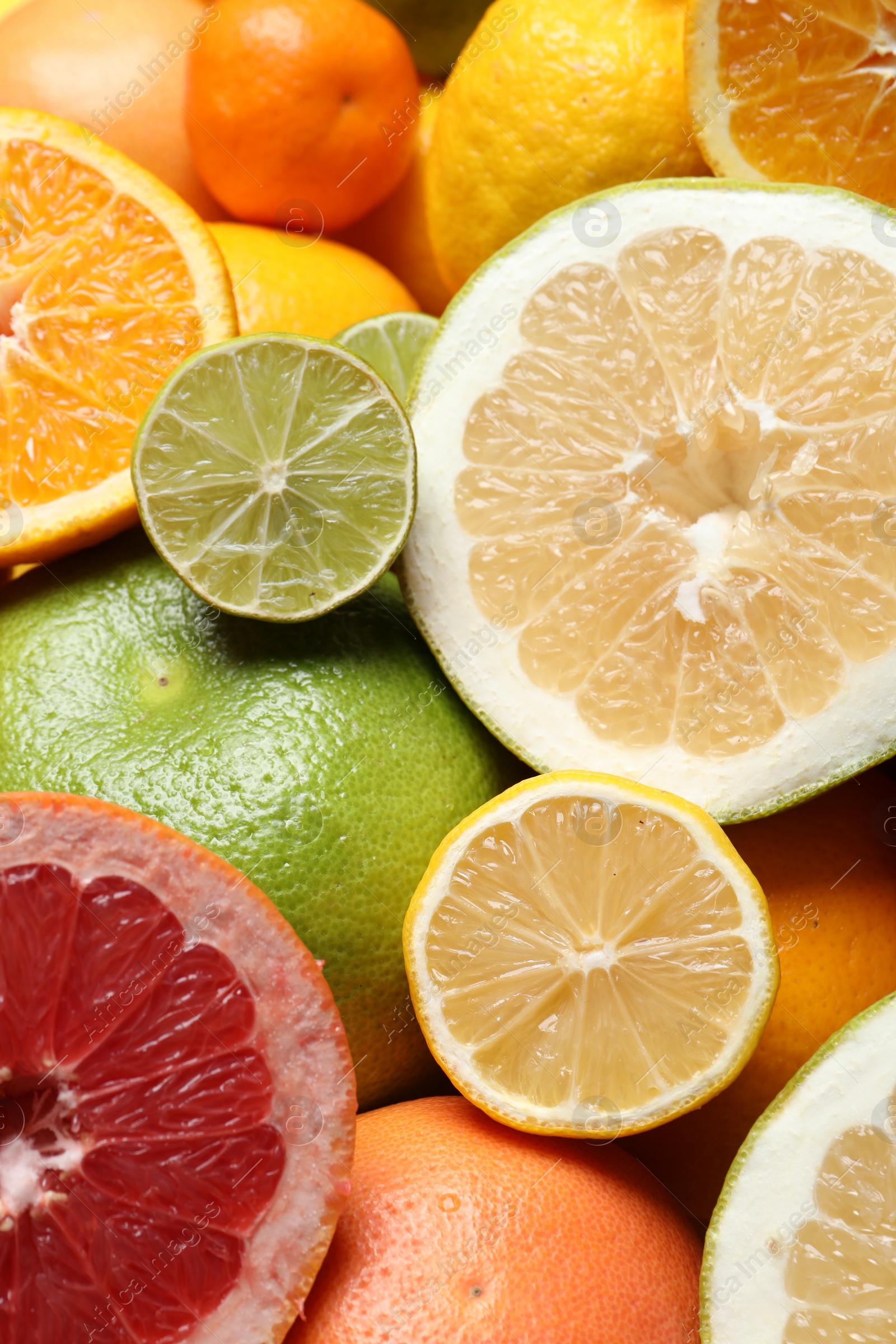 Photo of Different ripe citrus fruits as background, closeup