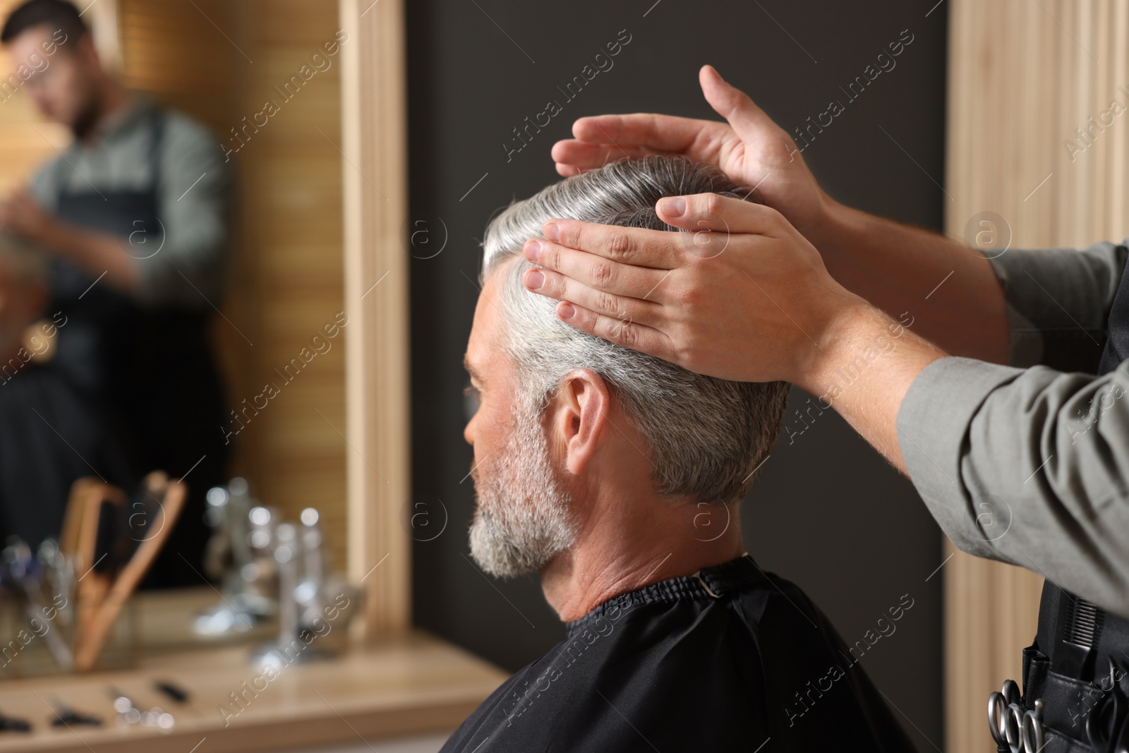 Photo of Hair styling. Professional hairdresser working with client in barbershop, closeup