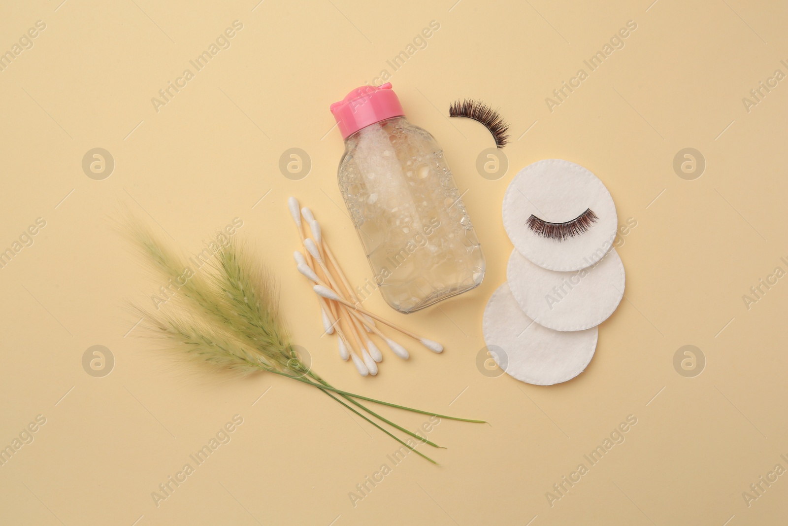 Photo of Flat lay composition with makeup remover and spikelets on yellow background