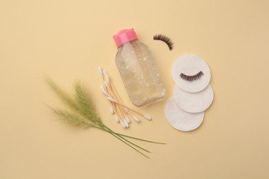 Photo of Flat lay composition with makeup remover and spikelets on yellow background