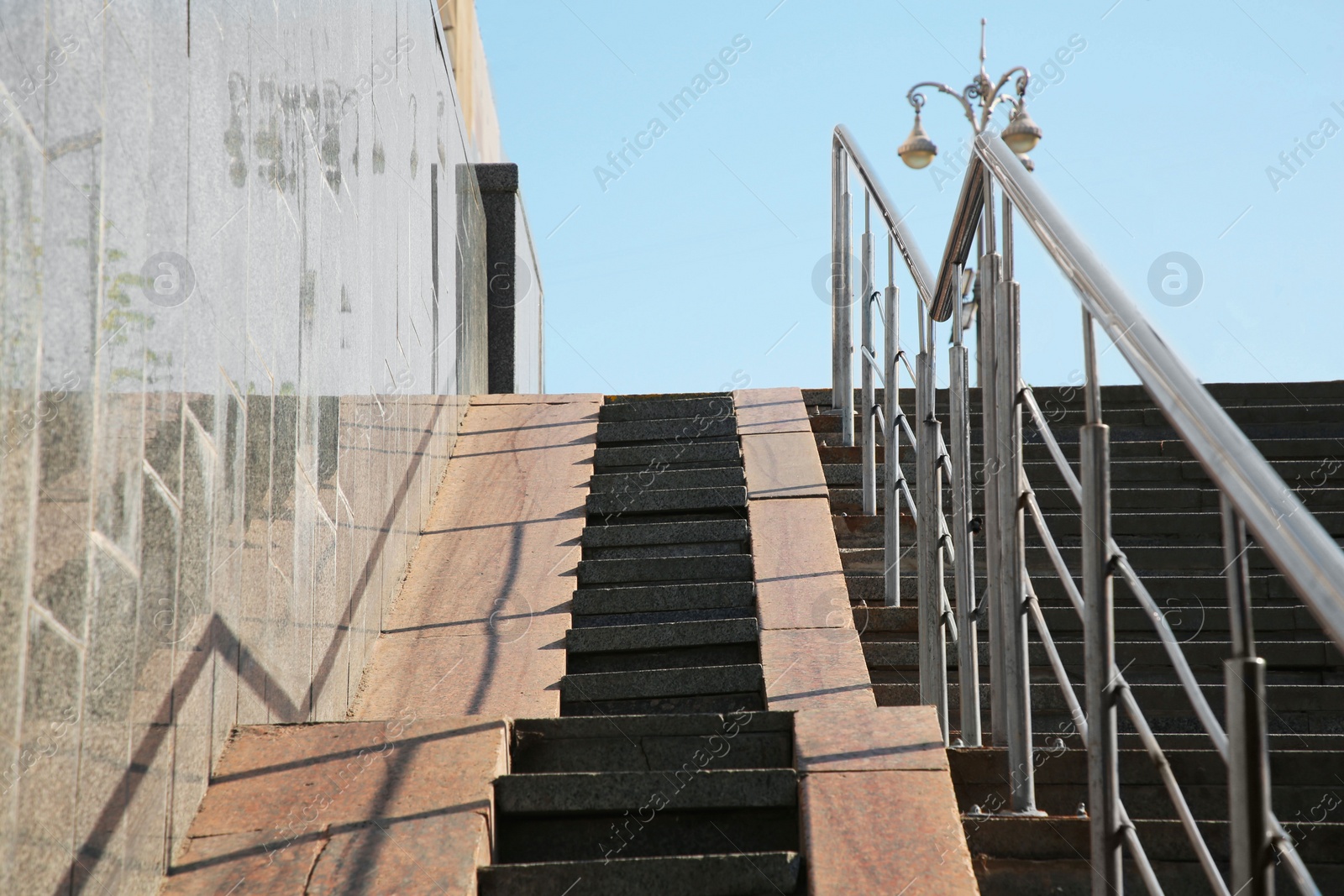 Photo of Staircase and ramp with metal handrail near building outdoors