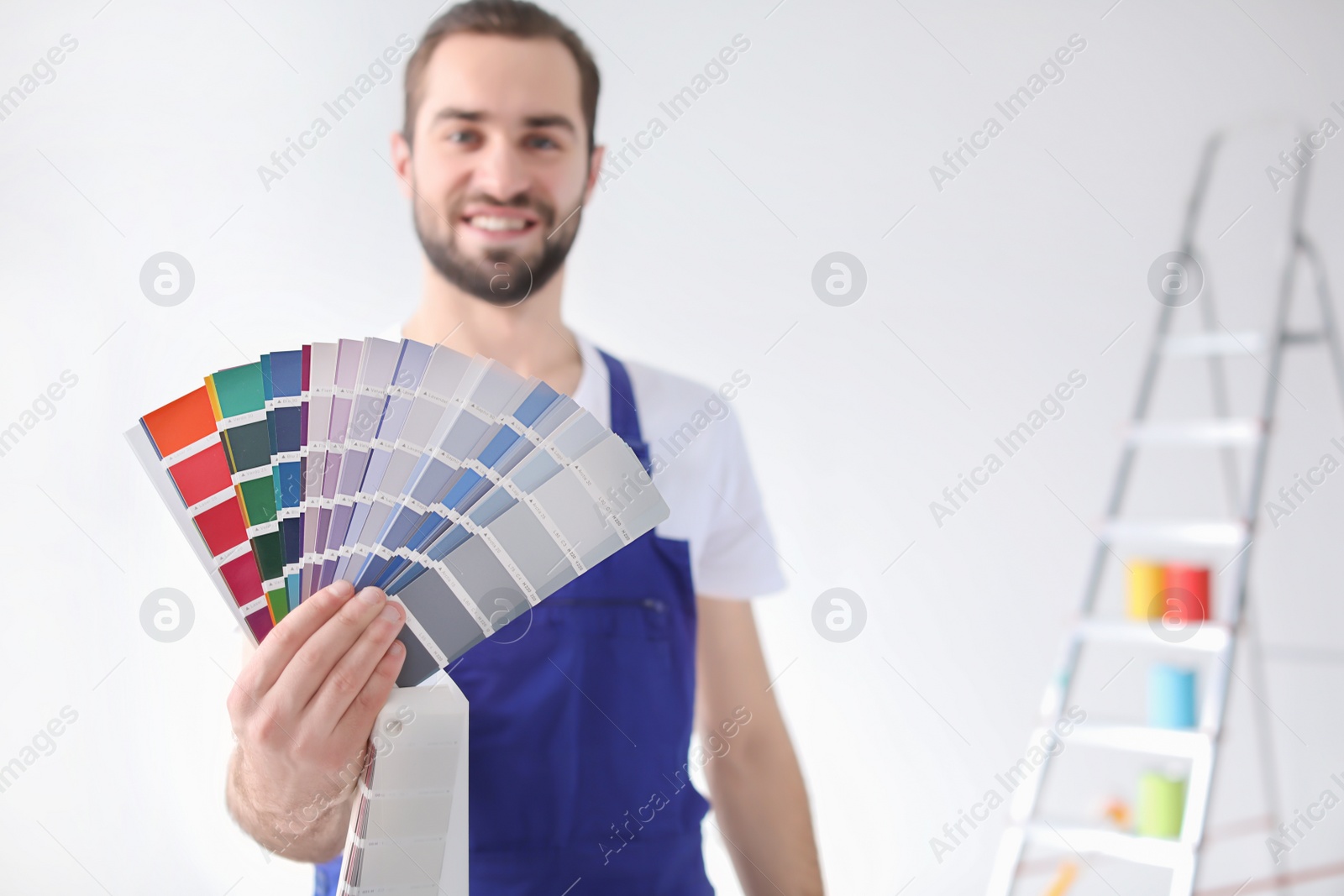 Photo of Male decorator with color palette on white background