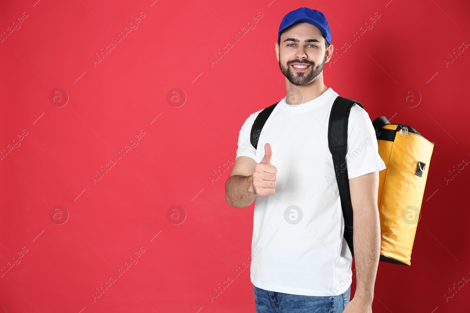 Photo of Courier with thermo bag on red background, space for text. Food delivery service