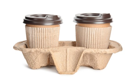 Photo of Takeaway paper coffee cups with sleeves in cardboard holder on white background