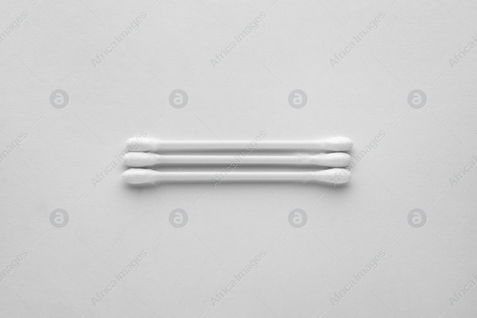 Photo of Clean cotton buds on white background, top view. Hygienic accessory