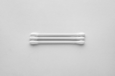 Photo of Clean cotton buds on white background, top view. Hygienic accessory