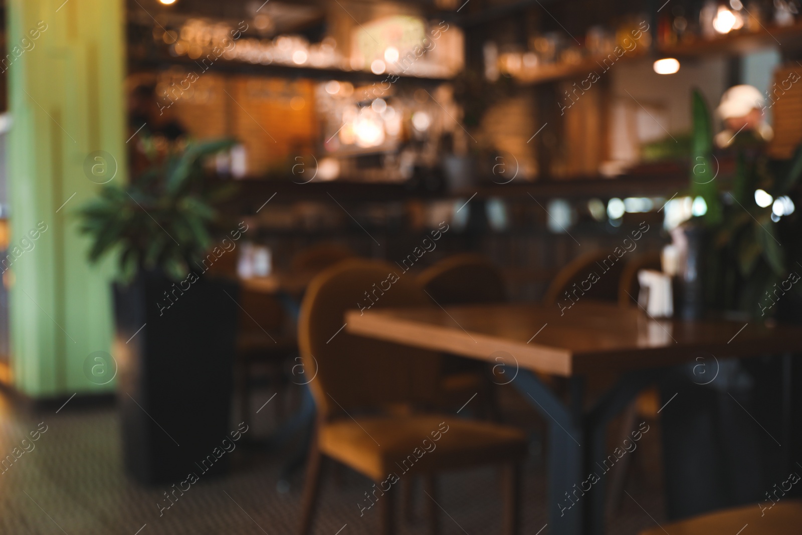 Photo of Blurred view of stylish modern cafe interior with bokeh effect