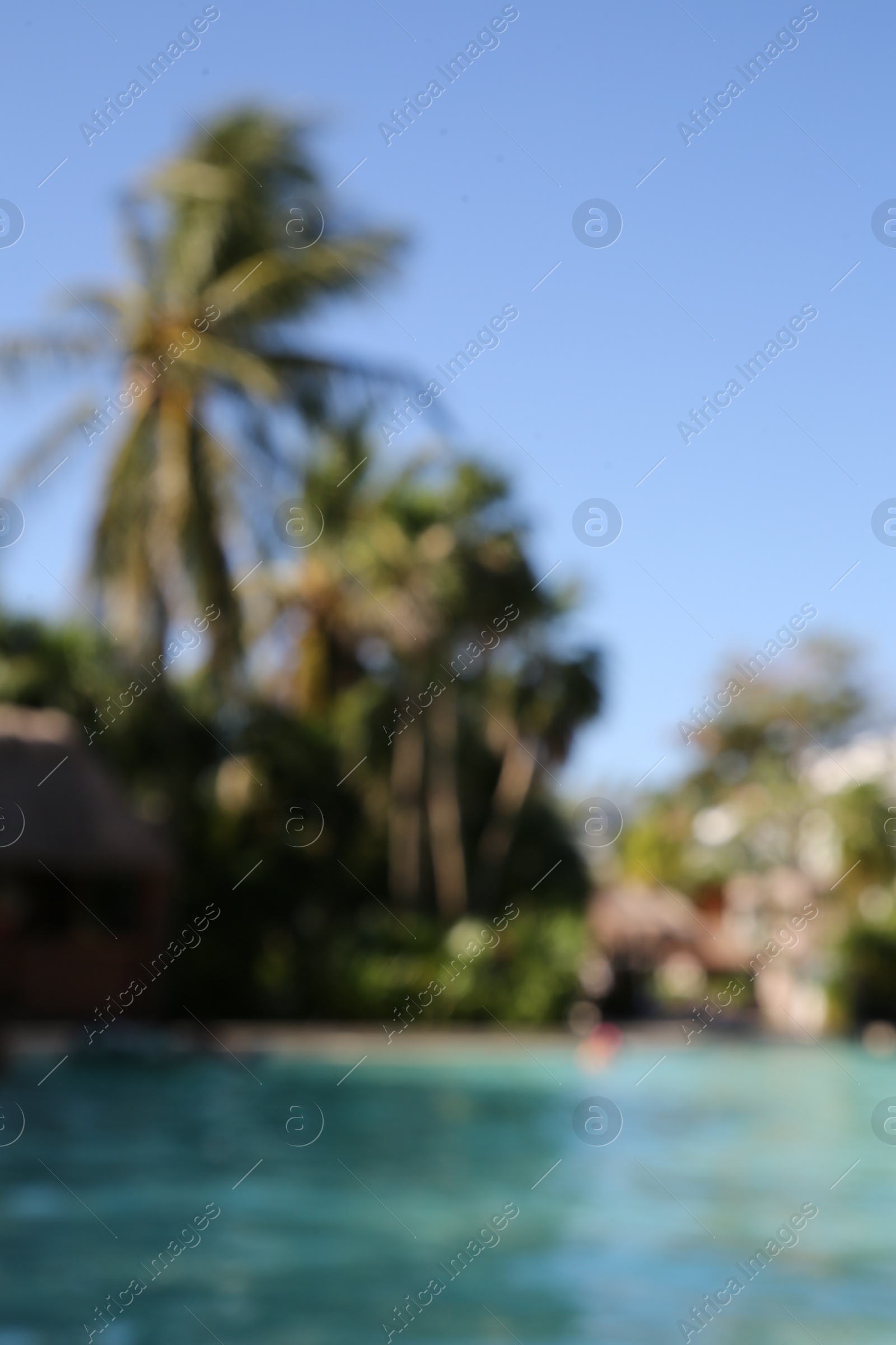 Photo of Blurred view of outdoor swimming pool at resort on sunny day