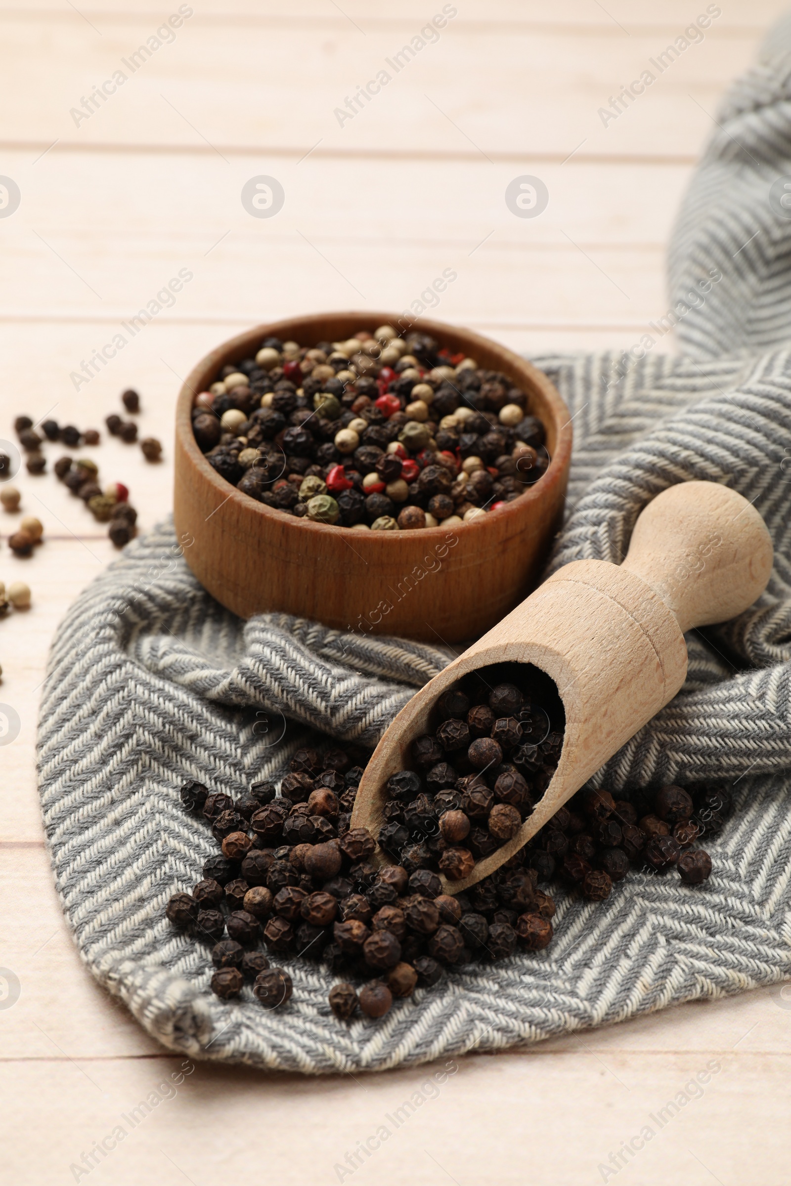 Photo of Aromatic spices. Different peppers on wooden table