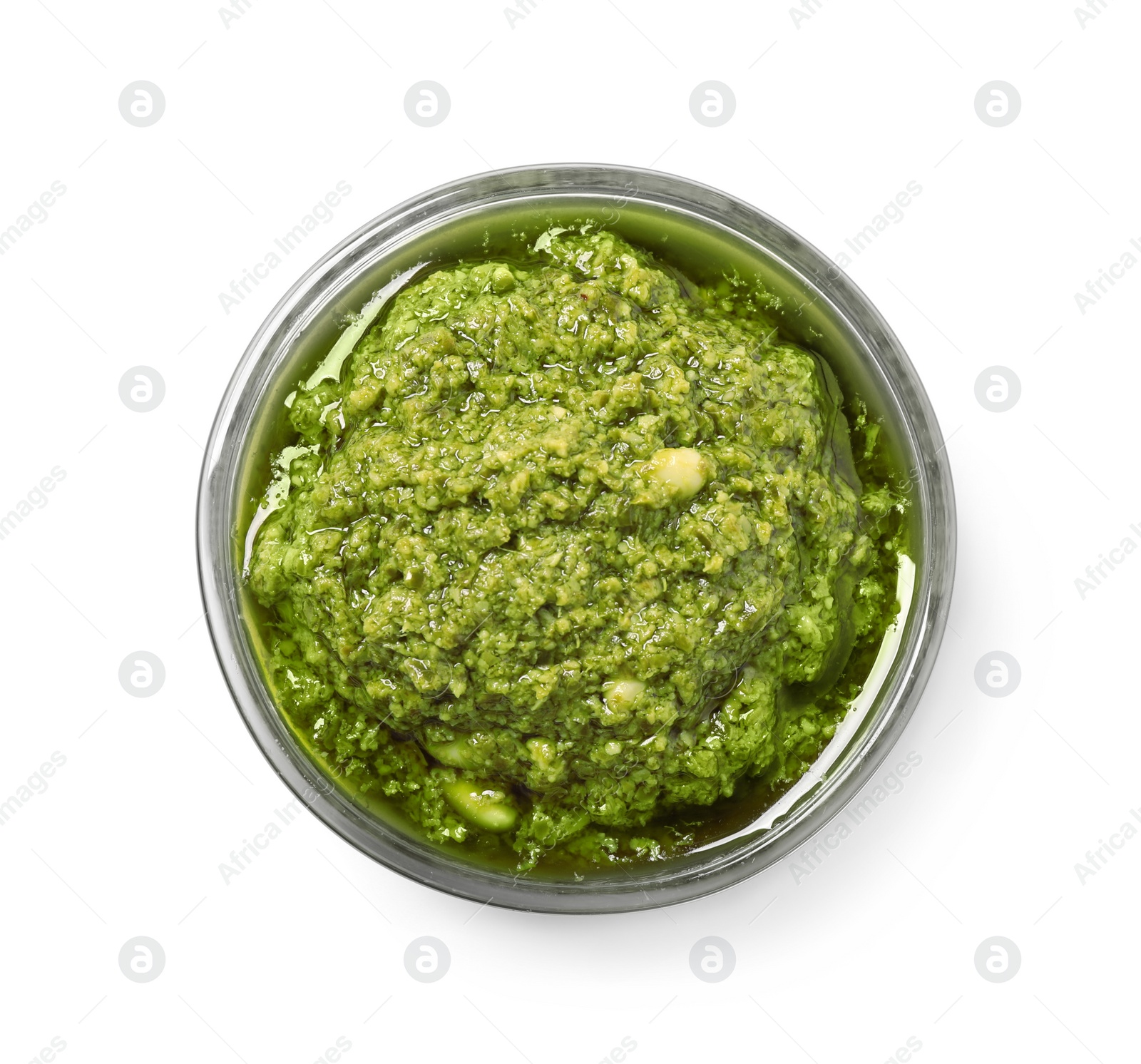 Photo of Bowl of tasty arugula pesto on white background, top view