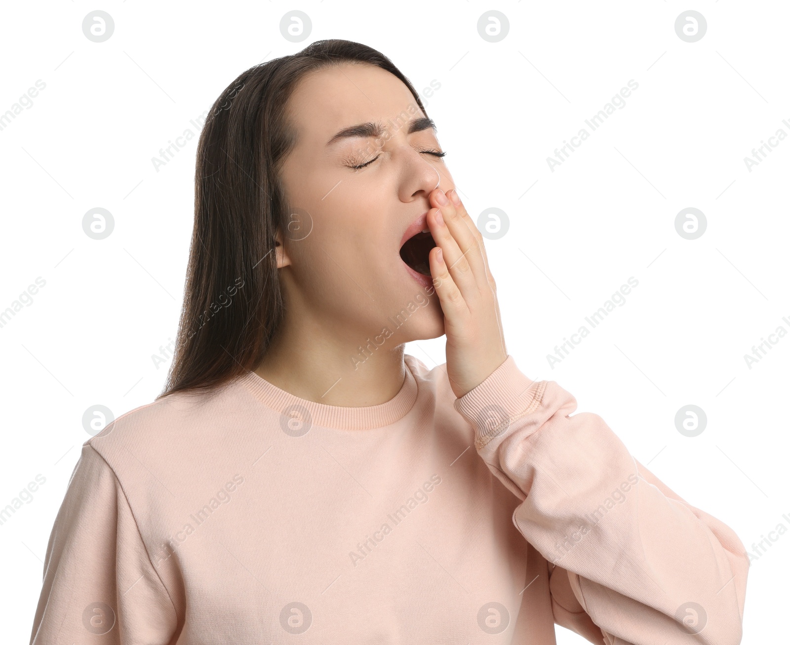 Photo of Young tired woman yawning on white background