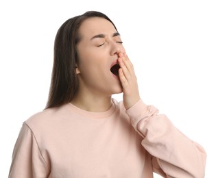 Young tired woman yawning on white background