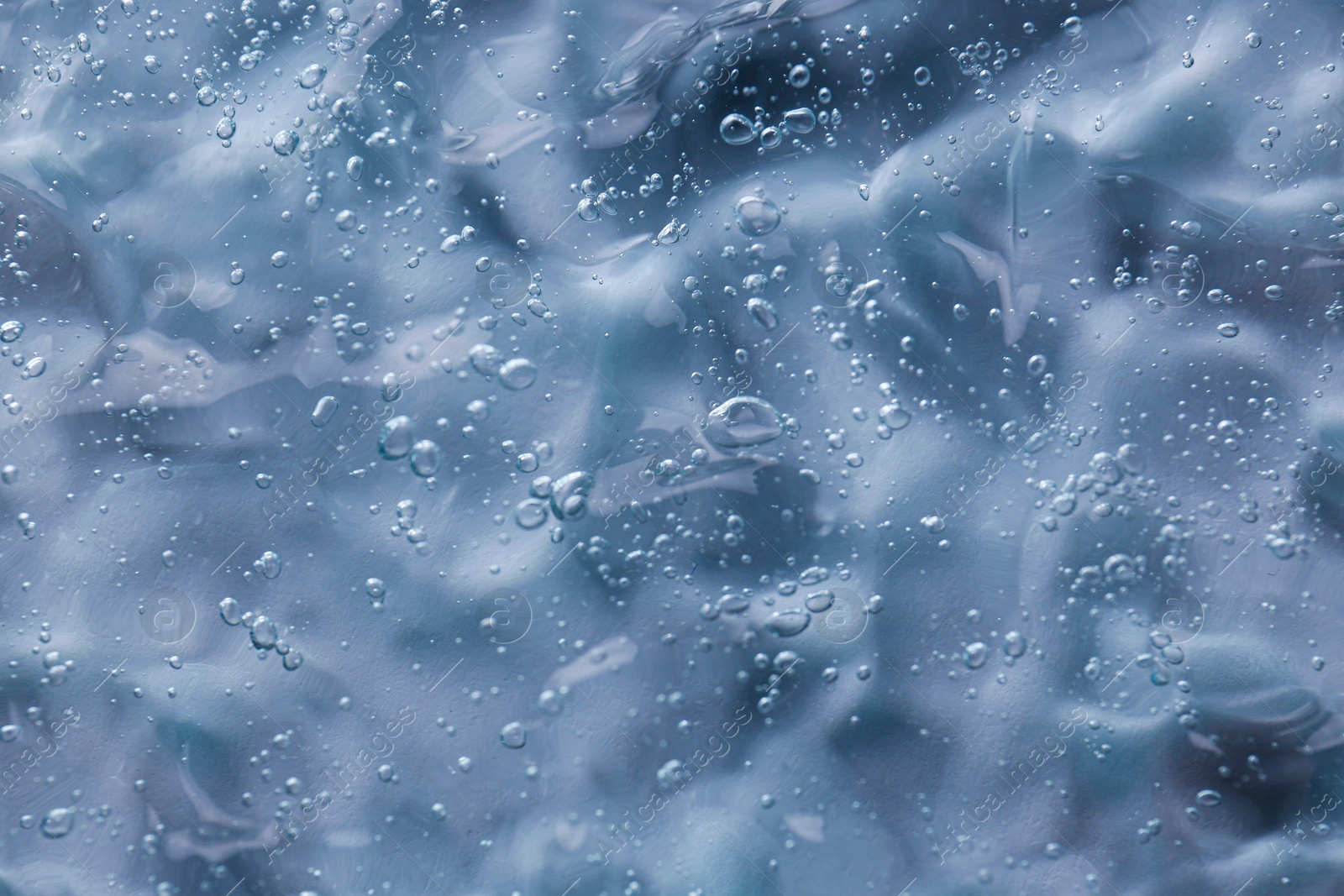 Photo of Texture of transparent shower gel as background, closeup