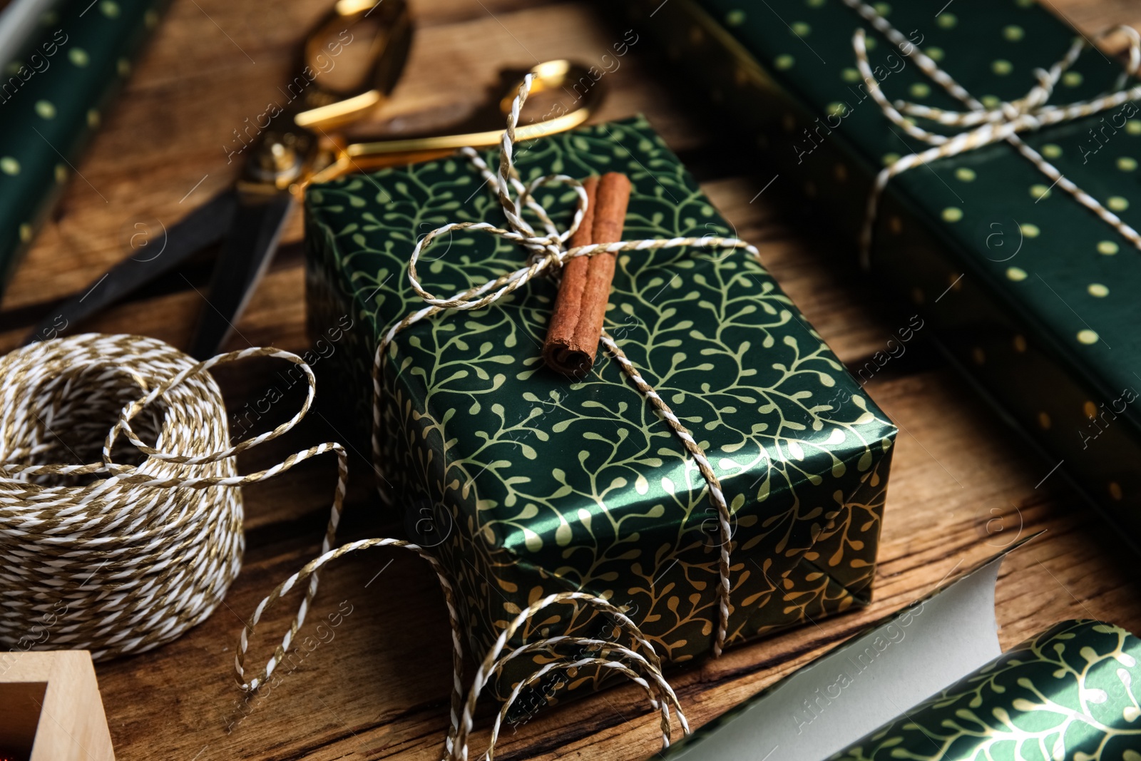 Photo of Composition with beautifully wrapped gift box on wooden table