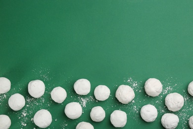 Photo of Snowballs on green background, flat lay. Space for text
