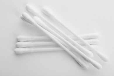Photo of Plastic cotton swabs on white background, top view