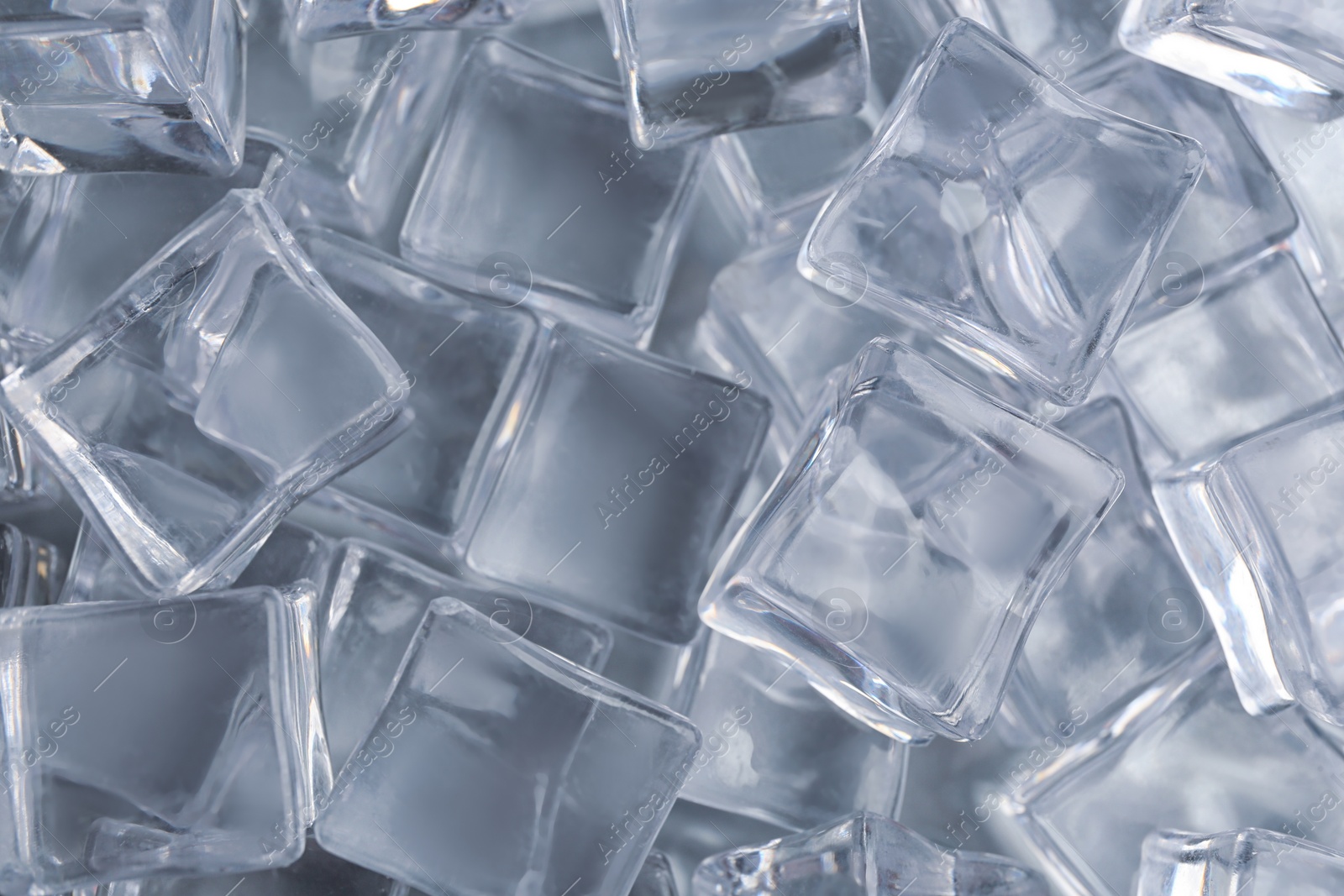 Photo of Crystal clear ice cubes as background, top view