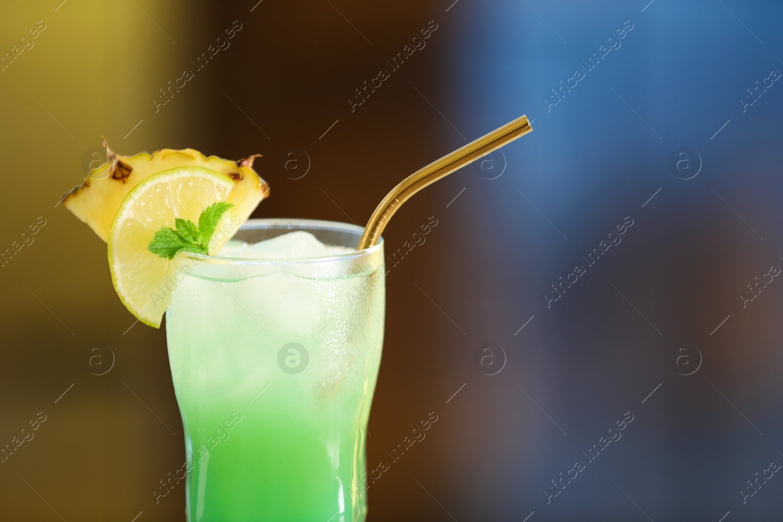 Photo of Fresh alcoholic cocktail with pineapple and lemon on blurred background, closeup. Space for text