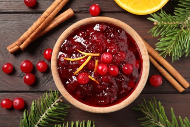 Flat lay composition with cranberry sauce on wooden table