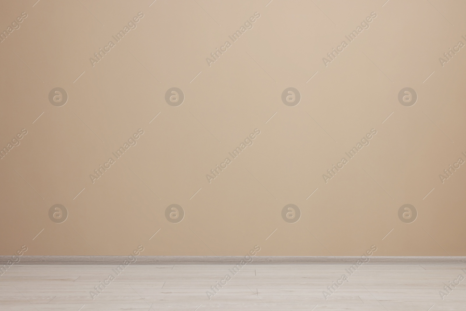 Photo of Empty room with beige wall and wooden floor