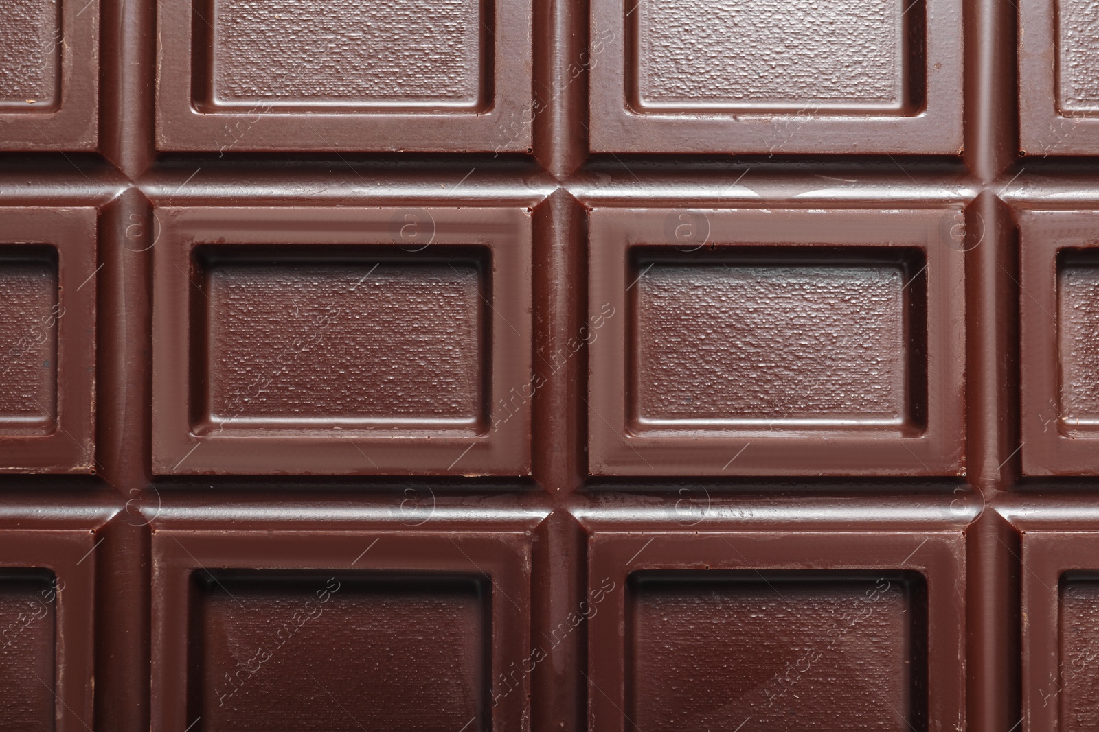 Photo of Tasty dark chocolate bar as background, top view