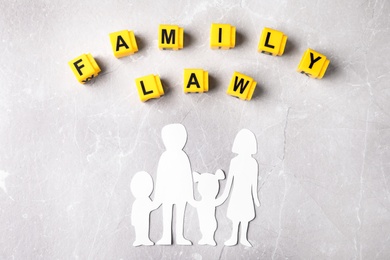 Photo of Cubes with words Family law and figure in shape of people on light background, flat lay