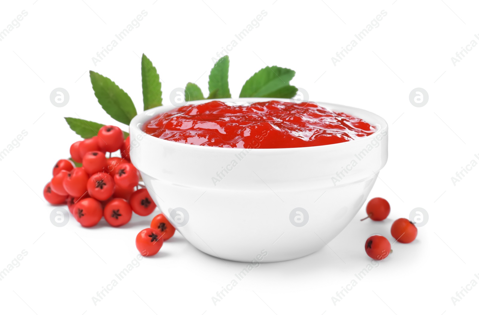 Photo of Delicious rowan jam in ceramic bowl and berries on white background