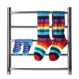 Photo of Modern heated towel rail with socks isolated on white