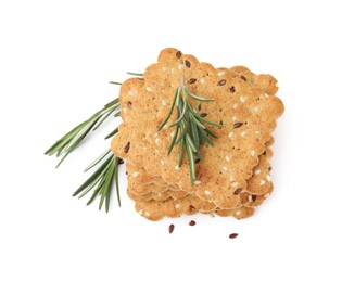 Photo of Stack of cereal crackers with flax, sesame seeds and rosemary isolated on white, top view