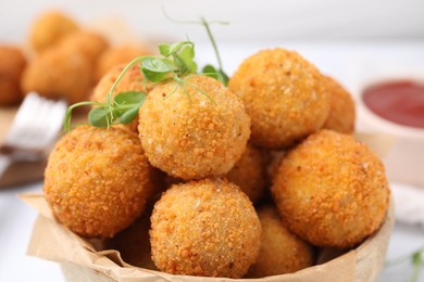 Delicious fried tofu balls with pea sprouts in bowl, closeup