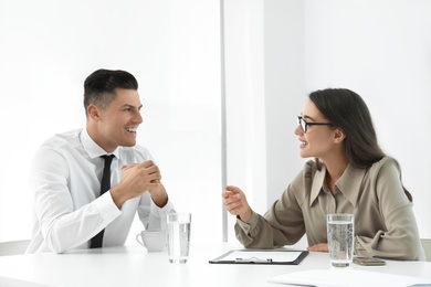 Office employees talking at table during meeting