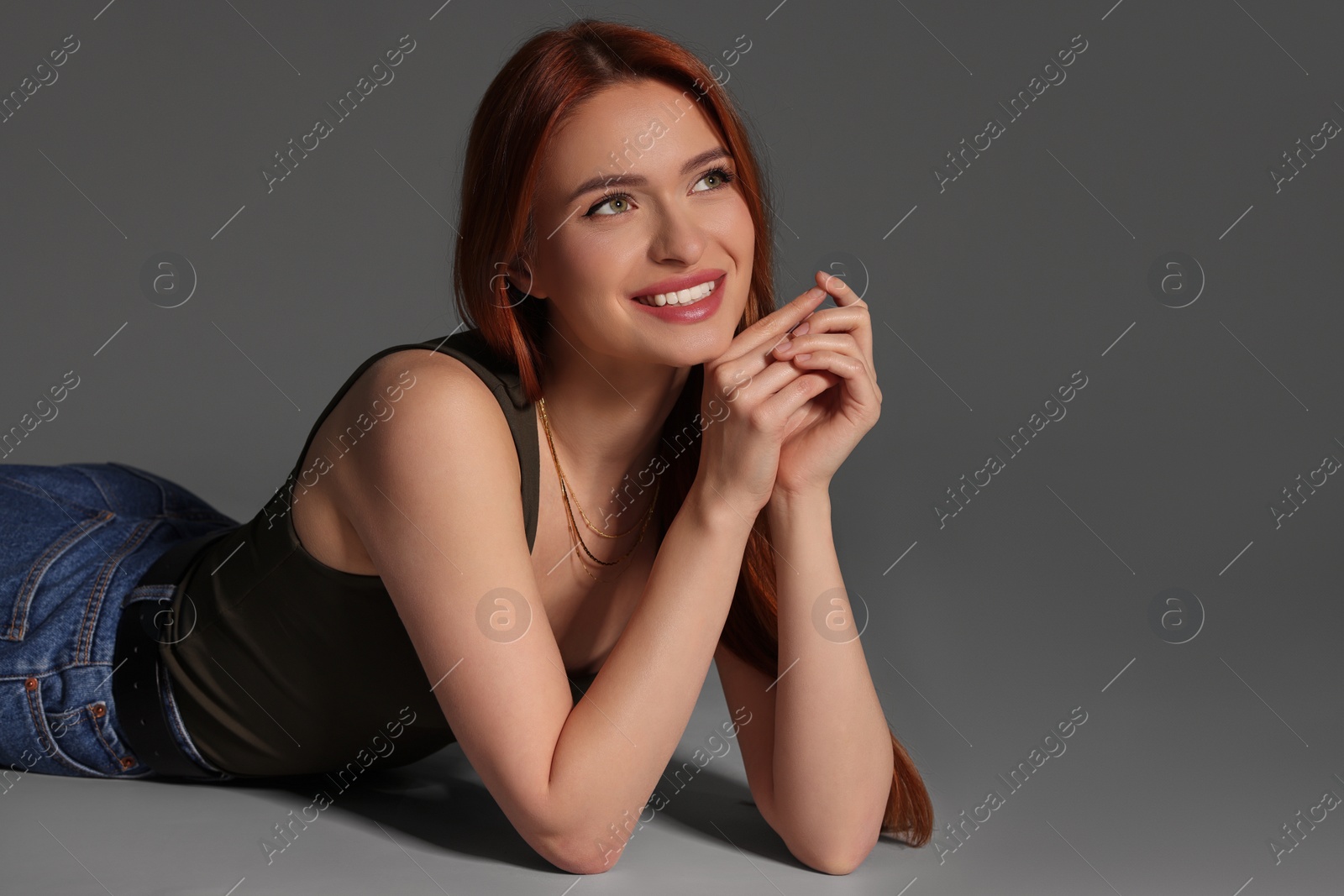 Photo of Portrait of beautiful young woman on gray background