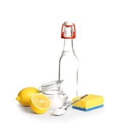 Photo of Composition with vinegar, lemons and baking soda on white background. House cleaning