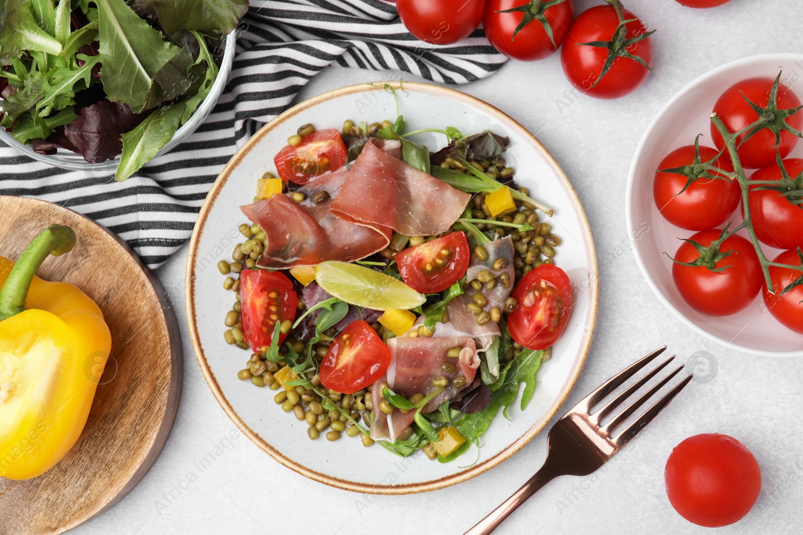 Photo of Plate of salad with mung beans on white table, flat lay