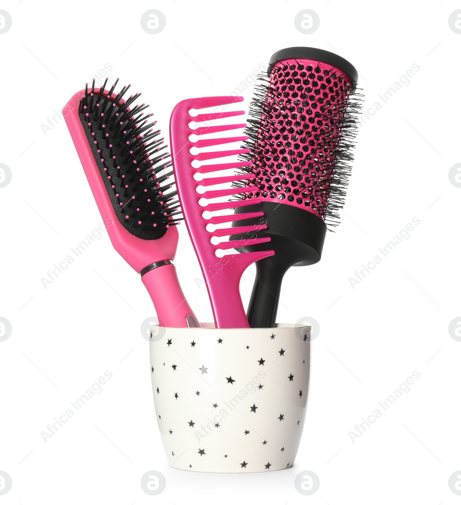 Photo of Hairbrushes and comb in holder on white background