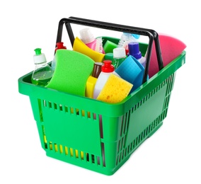 Photo of Green shopping basket with different household chemicals on white background